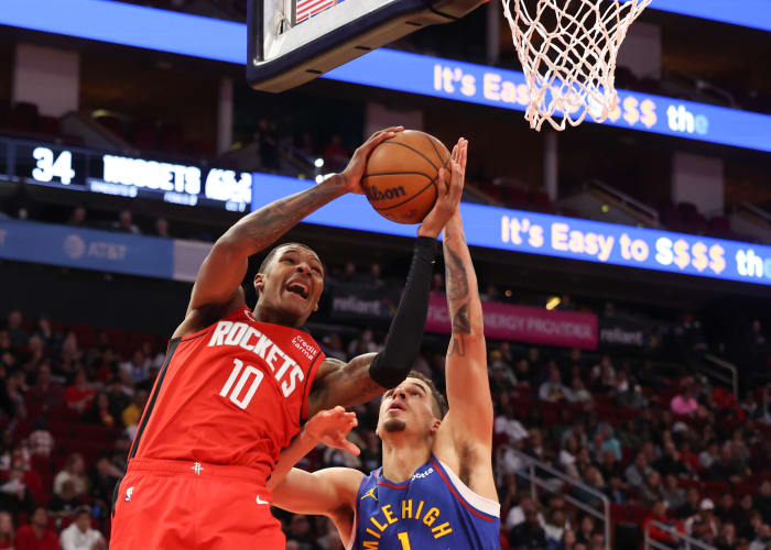 Rockets forward Jabari Smith Jr. scores against Denver Nuggets forward Michael Porter Jr. (1) in the second quarter at Toyota Center.